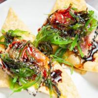 Ahi Tuna Nachos · Sashimi grade tuna on a bed of crispy fried wontons topped with a seaweed salad and drizzled...