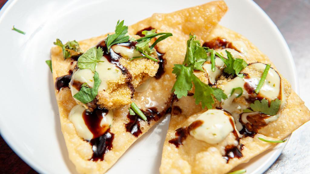Oysters · Cornmeal fried oysters served on a crispy wonton with habanero aioli and a balsamic reduction.
