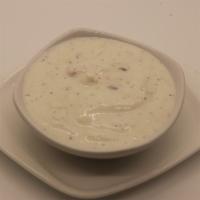 Raita · Cool homemade butter milk with potato, carrots, onion, and indian spices.