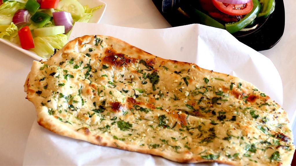 Garlic Naan · White unleavened bread with a garlic touch .butter on top