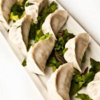 Momo (7 Pcs.) · Stuffed steamed dumplings seasoned with Himalayan herbs and spices, served with an exotic Ne...
