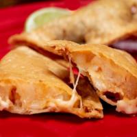 Empanada Ala · A crispy Mexican corn turnover filled with shrimp and Chihuahua cheese.