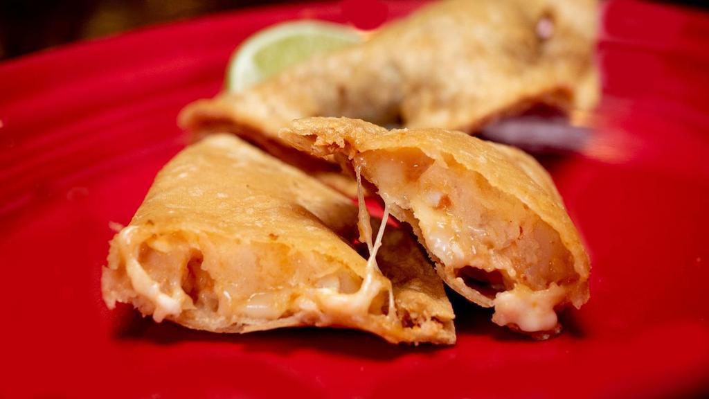Empanada Ala · A crispy Mexican corn turnover filled with shrimp and Chihuahua cheese.