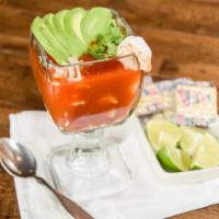 Coctel De Camaron · A delicious shrimp cocktail in a zesty tomato sauce. Garnished with onion, cucumbers, cilant...