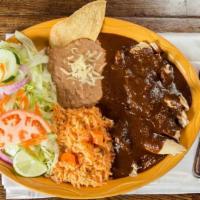 Pollo C/Mole · Tender pieces of chicken breast simmered in our delicious, home made mole sauce. Served with...