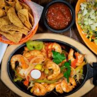 Fajitas De Camaron · Shrimp fajitas grilled with slices of onion, tomatoes and colorful bell peppers. Served with...