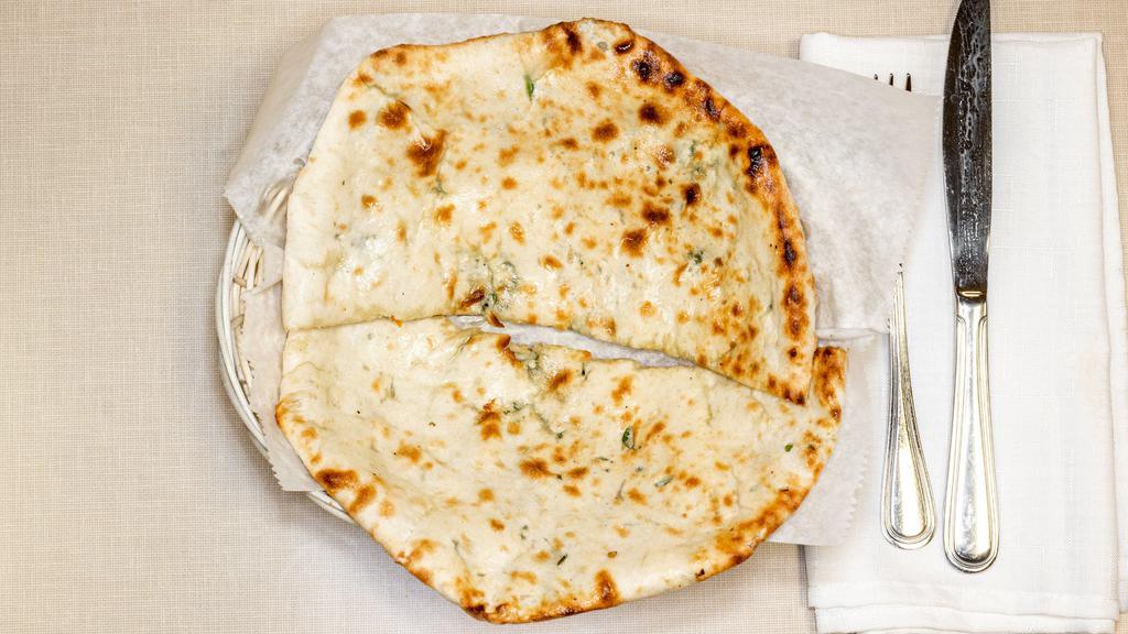Chilli Cheese Naan · Bread baked in Tandoor grill stuffed with cheese and chillies and made to perfection.