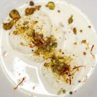 Milk Dumpling · Snowy  Oats of sweetened Milk in Rose water flavored Milk and garnished with Pistachio Nuts.