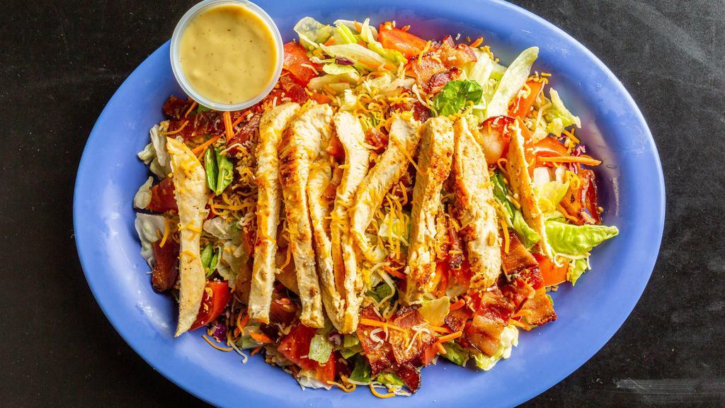 Club Salad · Iceberg lettuce, carrots and tomatoes topped with grilled chicken, bacon, and shredded cheese.