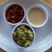 Chips, Guac, Salsa & Queso Blanco · Tortilla chips served with house-made guacamole, chunky salsa & queso blanco.