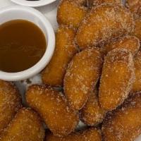 Churro Donuts · Fried- to-order donuts tossed in cinnamon, sugar & served with caramel and chocolate sauce.