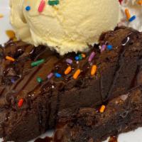 Brownie Sundae · Warm brownie topped with vanilla ice cream, whipped cream, sprinkles, caramel and chocolate ...