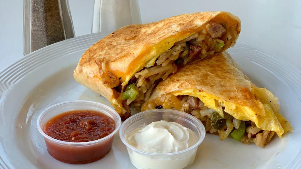 Classic Breakfast Burrito · Two scrambled eggs, hashbrown, choice of classic meat, and melted cheese wrapped in a fresh flour tortilla.