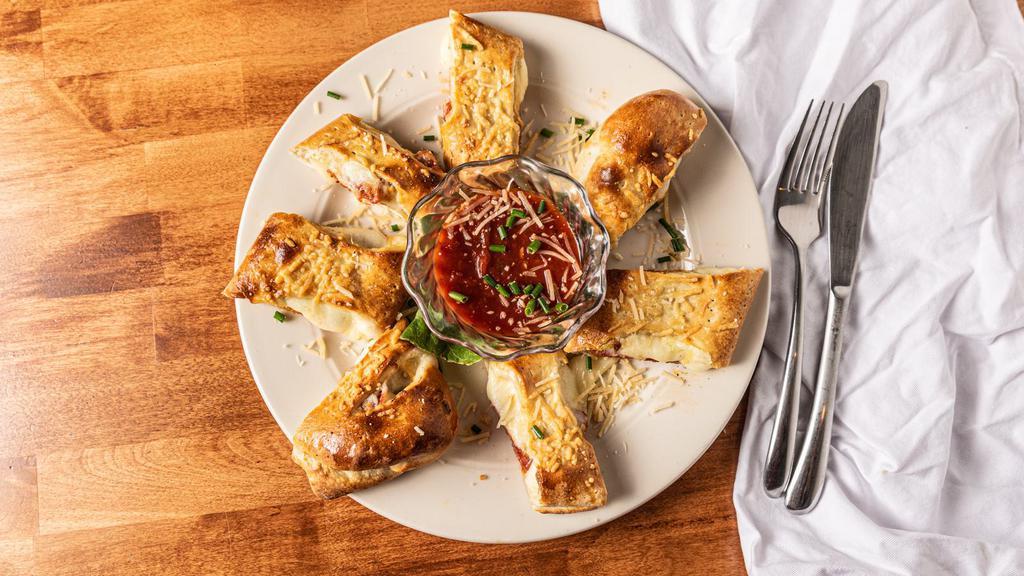 Pepperoni Pizza Rolls · Pepperoni and mozzarella cheese rolled up on a homemade pizza crust and cut into bite-size pieces. Served with marinara dipping sauce.