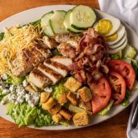 Cobb Salad · Fresh-grilled chicken breast served on a bed of mixed greens with applewood smoked bacon, to...