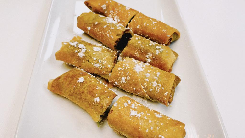 Sweet Red Bean Paste Spring Roll (4 Pieces) · Spring rolls with sweet red bean paste and power sugar on top.