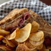 Reuben Sandwich · Corned beef on marble rye, topped with swiss cheese, sauerkraut, pickle and sully's secret s...