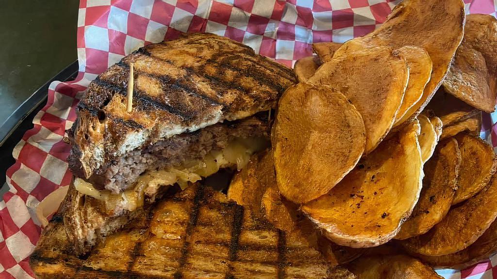 Paddy Melt · Half-pound ground brisket burger topped with sautéed onions and Swiss cheese on rye bread.