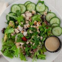 Caribbean Chicken · grilled chicken, avocado, cucumber, cherry tomatoes, spring mix, toasted coconut flakes, ses...