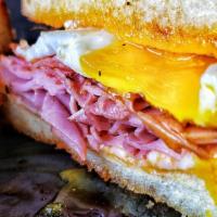 Breakfast Grilled Cheese · Canadian Bacon with Cheddar, Mozzarella and an Over Easy Egg with Sour Cream on Thick-Cut Te...