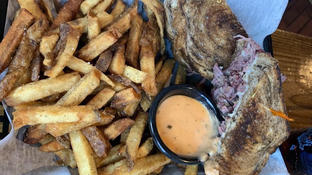 Shredded Corned Beef Reuben · Our corned beef is slow-roasted in-house until it falls apart, and topped with fried kraut and Swiss cheese. Served on grilled marble rye with Thousand Island for dipping.