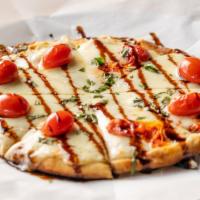 Caprese Flatbread · Olive oil, roasted grape tomatoes, mozzarella, and fresh basil, drizzled with a balsamic gla...