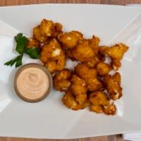 Beer Battered Cheese Curds · Minnesota classic beer battered white cheddar cheese curds, served with a chipotle dipping s...