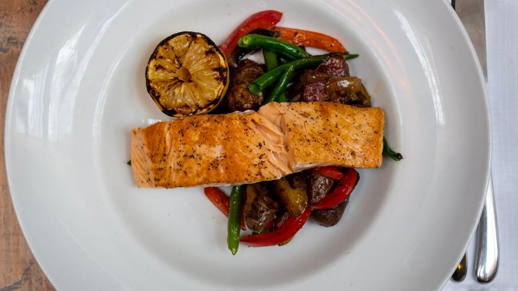 Pan Seared Salmon* · Gluten free. Roasted red potatoes, green beans, mushrooms, roasted red peppers caramelized onions, herb butter.
