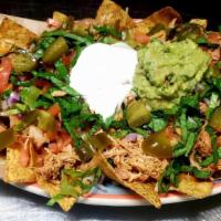 Super Nachos · Tortilla chips with beans, cheese, lettuce, tomato, sour cream, onion, guacamole and pickled...