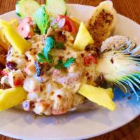 Pina Rellena  · Half Pineapple stuffed with seafood mix and cheese. Served with side of rice & beans or rice...
