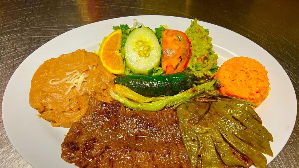 Carne Asada · Grilled skirt steak cooked to your order with grilled cactus. Served with rice, beans, salad, and tortillas.