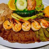 Mar Y Tierra · Grilled skirt steak topped with shrimp and grilled cactus. Served with rice, beans, salad, a...