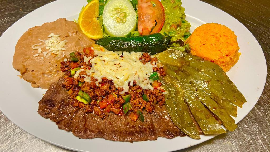 Carne Nortena  · Skirt Steak with chorizo mixed with jalapeño topped with cheese. Served with side of rice & beans and tortillas.