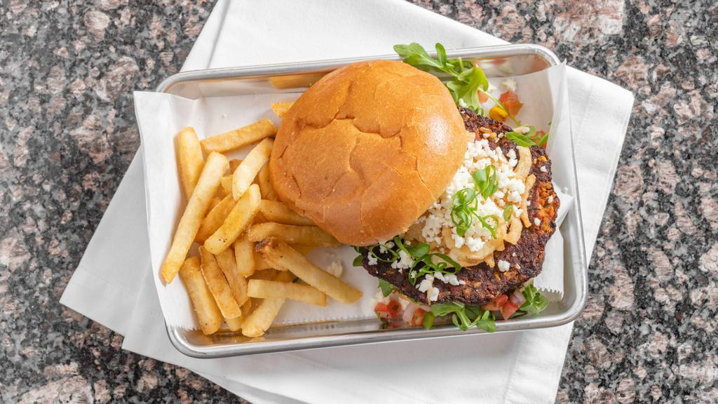 Chipotle Black Bean Burger · Take a bite out of this vegetarian burger from the grill topped with arugula, Pico de Gallo, green onions, signature sauce, crispy fried onions, and finish with queso fresco. Served with fries