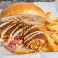Blackened Chicken Sandwich · Cajun style seared chicken on a toasted brioche bun topped with tomatoes, pickles, sauteed o...