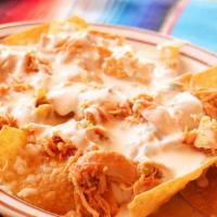 Chicken Nachos · Crispy corn tortilla chips topped with chicken and cheese dip.