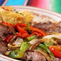 Ranchero Chef Special · Tender Rib Eye,with grilled onions,bells peppers,tomatoes, a chicken Enchilada, bean and pic...