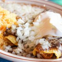 Enchiladas Poblanas · 3 chicken enchiladas topped with onios sour cream and mole served with rice and beans