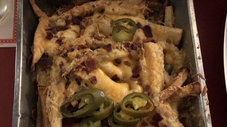 Loaded Fries · House-cut fries covered with Colby-Jack cheese, bacon and jalapeños. Served with ranch.