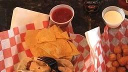 Chips & Queso · Fire roasted salsa and home-made queso served with crisp tortilla chips.