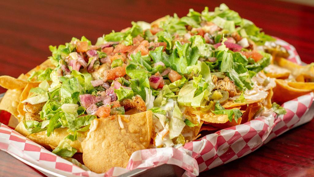 George’S Deep Dish Nachos · A pile of fresh tortilla chips with melted Colby-Jack cheese,queso, jalapeños, tomato, onion, and lettuce. Sour cream and salsa on request.