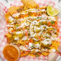 Super Nachos · fried tortilla cut in quarter size, , meat of your choice, beans, coriander, onion, milk cre...