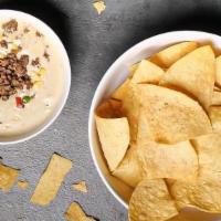 House Chips And Queso · Shareable portion of House White Jalapeno Queso and Seasoned Chips. *Add-ons Available for a...