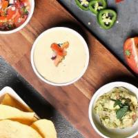 Crunch Dip Trio · House seasoned corn chips, served with guacamole, weekly house salsa , and white jalapeño qu...