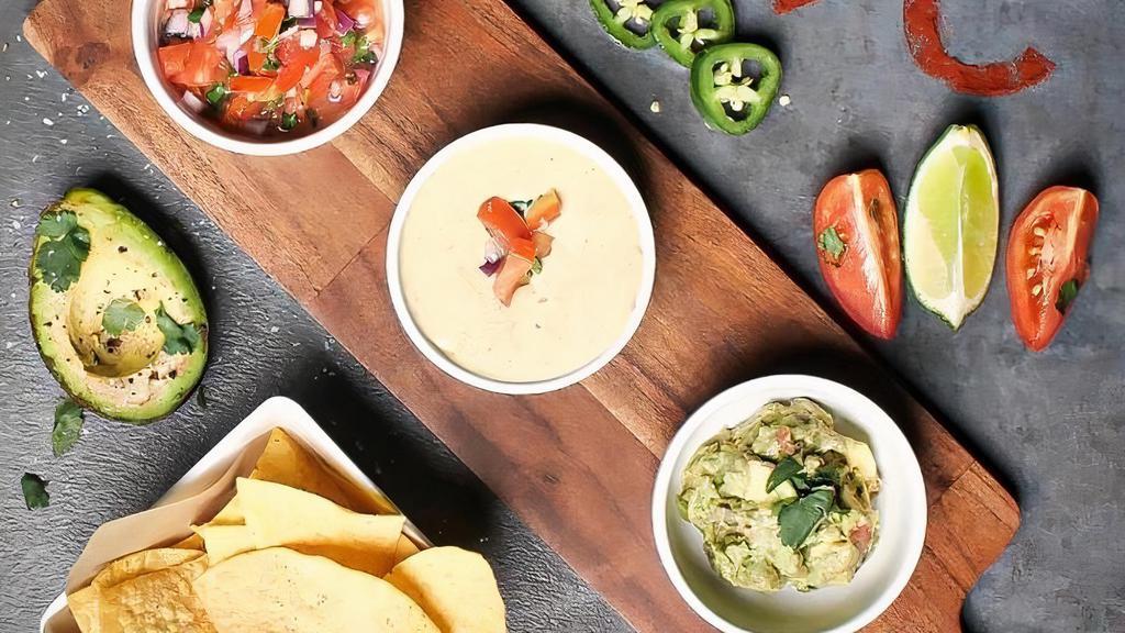 Crunch Dip Trio · House seasoned corn chips, served with guacamole, weekly house salsa , and white jalapeño queso.