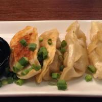 Chicken Pot Stickers · Potstickers seared with an Asian dipping sauce.