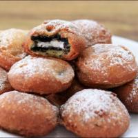 Fried Oreos · Four oreo cookies deep fried and served with hershey's hot fudge.