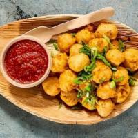 Paneer Poppers · VEGETARIAN. Extra-firm cheese battered and fried crispy served with Red-Hot sauce