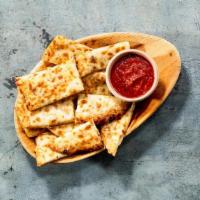 Cheesy Garlic Naan Bites · Signature Naan smothered with garlic & cheese served with Red-Hot sauce