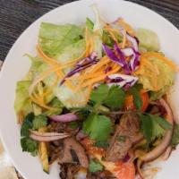 Beef Salad · Medium-hot. Grilled sliced beef with fresh herb, tomato, cucumber, carrot, cilantro, red oni...